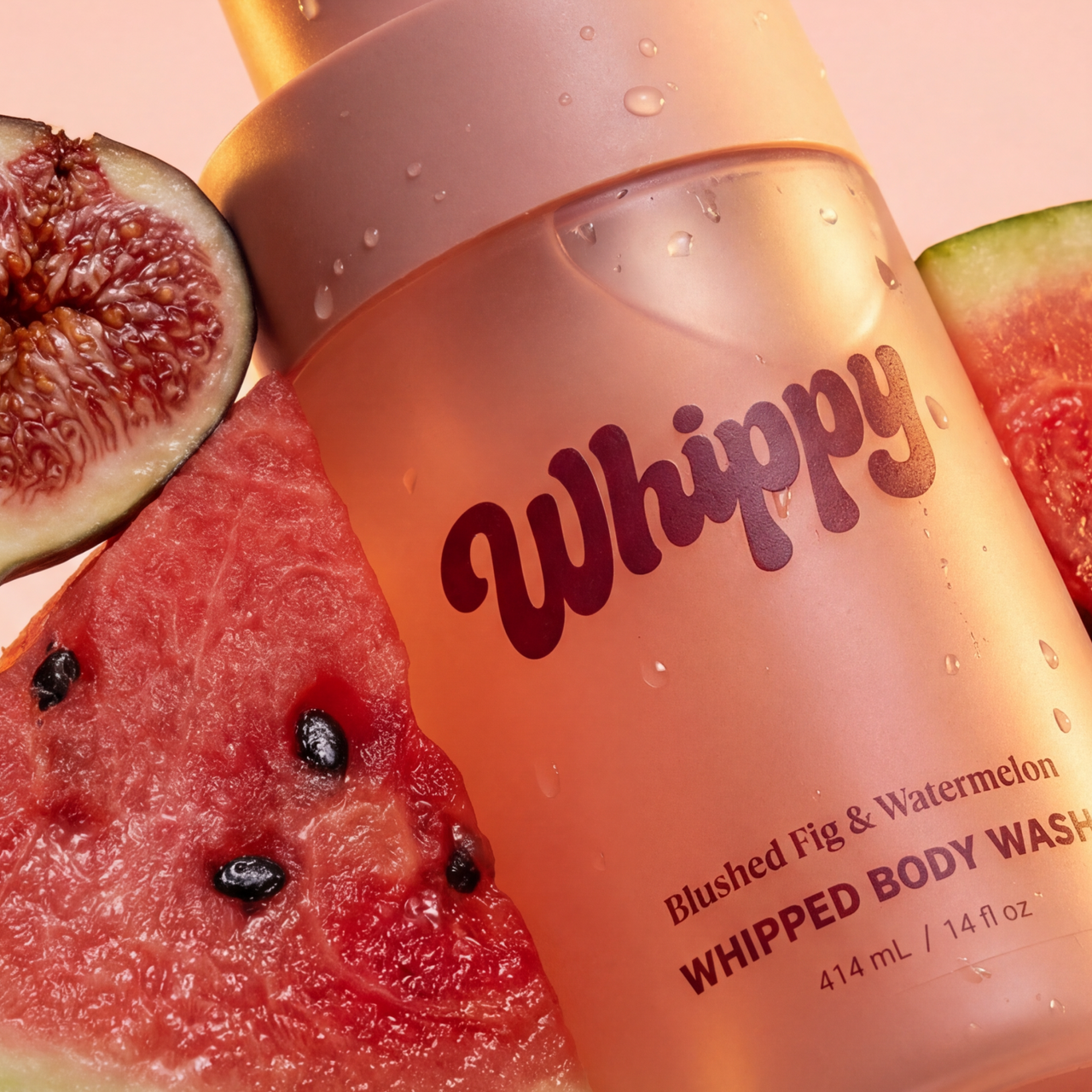 Whippy Blushed Fig & Watermelon Whipped Body Wash bottle with fresh sliced figs and watermelon