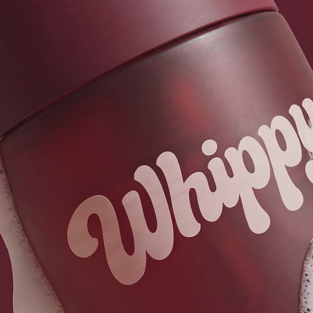 Close-up of Whippy Black Cherry & Coconut Milk Whipped Body Wash bottle with foam lather
