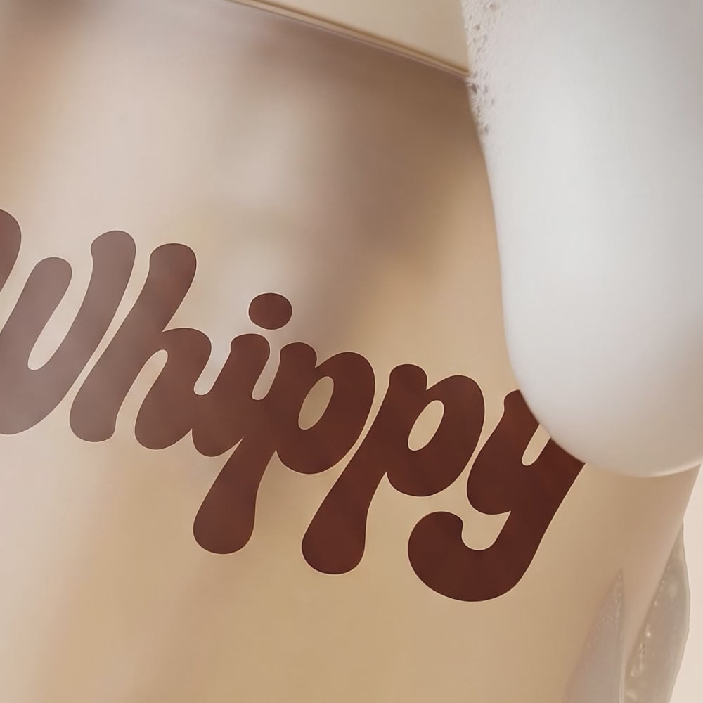 Close-up of Whippy Ambered Vanilla Sugar Whipped Body Wash bottle with foam lather