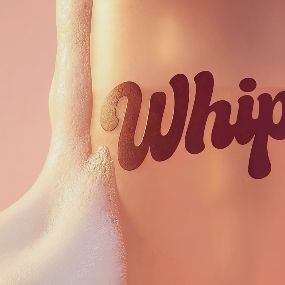 Close-up of Whippy Blushed Fig & Watermelon Whipped Body Wash bottle with foam lather